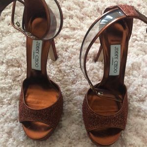 Rust colored ankle strap open toe Choo heels.